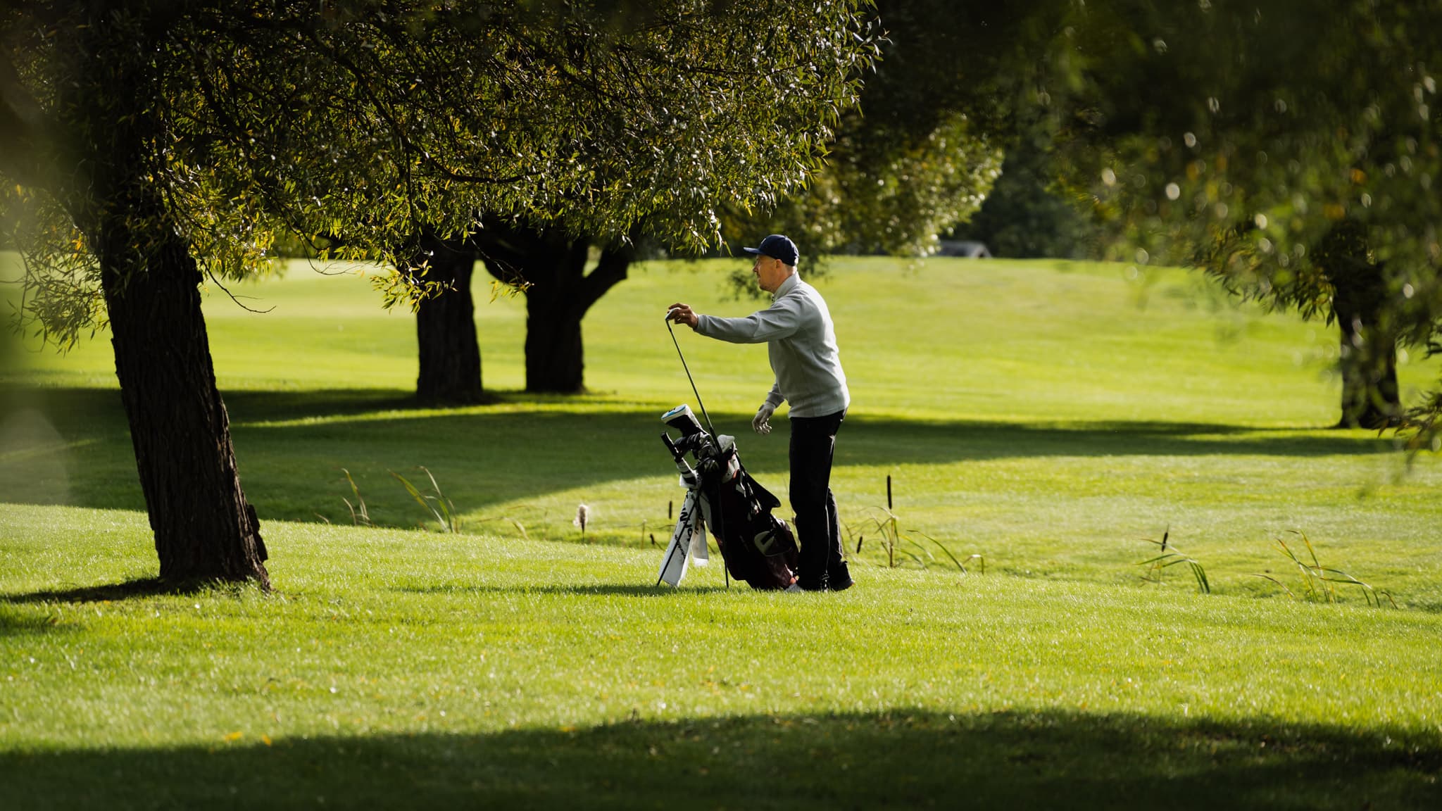 Golfer between trees at St. Laurence Golf